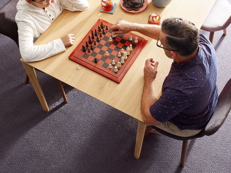 playing chess with boy on the living room table | Canyon Floor Corporation \ Canyon Floors |